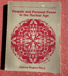 photo of book Despair and Personal Power in the Nuclear Age by Joanna Macy with a cover image created by Mara Loft